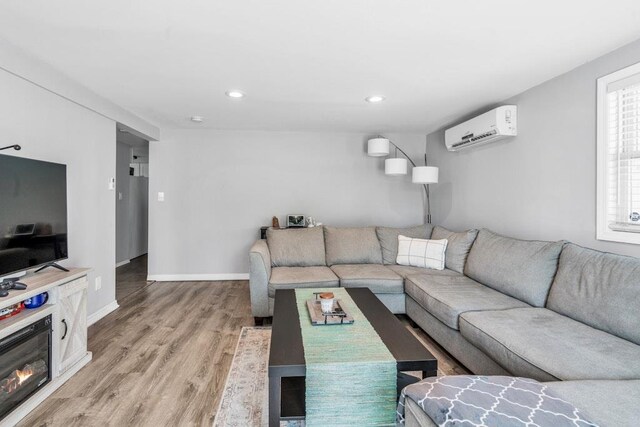 544 S 15th St, Lindenhurst, NY 11757 - living area featuring a wall mounted air conditioner, light wood-style floors, and recessed lighting
