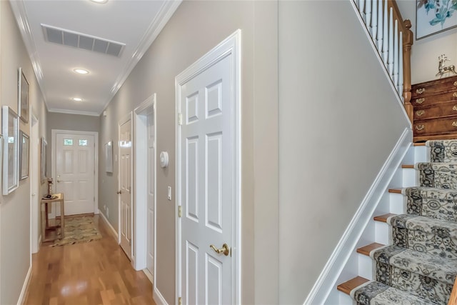 122 Maya Cir, Central Islip, NY 11722 - hallway featuring crown molding, stairs, light wood-style floors, and recessed lighting
