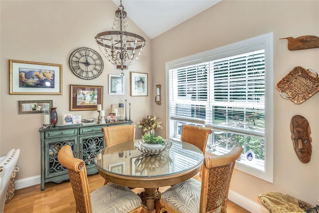 122 Maya Cir, Central Islip, NY 11722 - dining area with a chandelier, vaulted ceiling, and light wood-type flooring