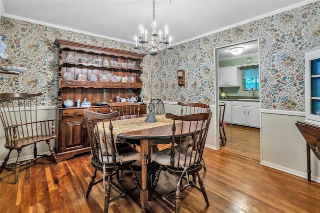 29 Cardinal Ln, Hauppauge, NY 11788 - dining space with wallpapered walls, wainscoting, wood finished floors, crown molding, and a chandelier