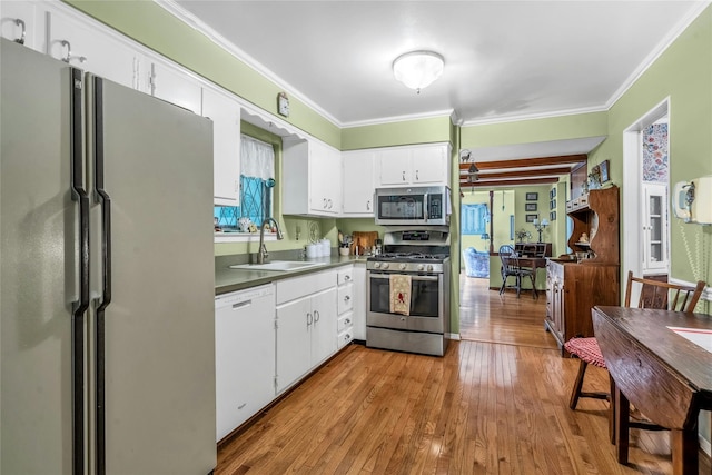 29 Cardinal Ln, Hauppauge, NY 11788 - kitchen featuring stainless steel appliances, wood finished floors, crown molding, and white cabinetry