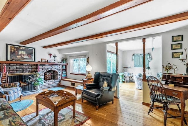 29 Cardinal Ln, Hauppauge, NY 11788 - living room featuring light wood-style flooring, a brick fireplace, and beamed ceiling