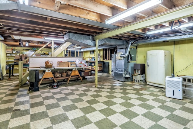 29 Cardinal Ln, Hauppauge, NY 11788 - unfinished below grade area featuring a workshop area, tile patterned floors, gas water heater, and heating unit