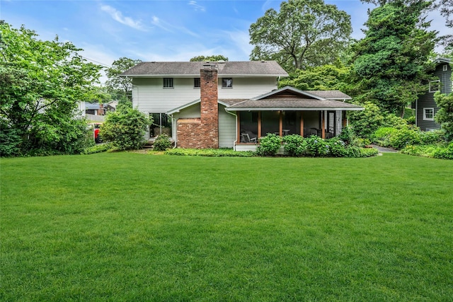 29 Cardinal Ln, Hauppauge, NY 11788 - view of front facade featuring a front lawn, a sunroom, a chimney, and a shingled roof