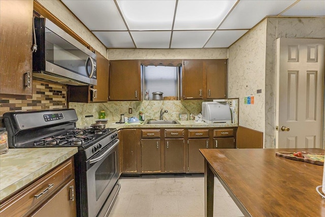 4026 Wickham Ave, Bronx, NY 10466 - kitchen with stainless steel appliances, decorative backsplash, wooden counters, and a drop ceiling