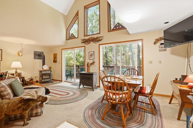 16 Canal Rd, Wurtsboro, NY 12790 - dining room with a wood stove, light colored carpet, and lofted ceiling