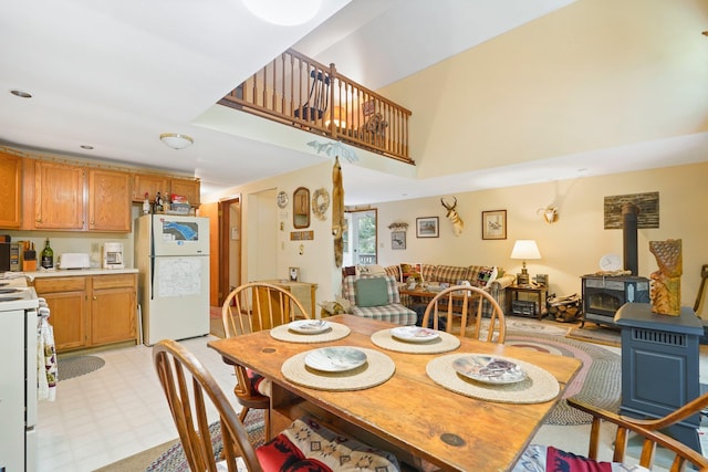 16 Canal Rd, Wurtsboro, NY 12790 - dining area featuring a wood stove, light floors, and a towering ceiling