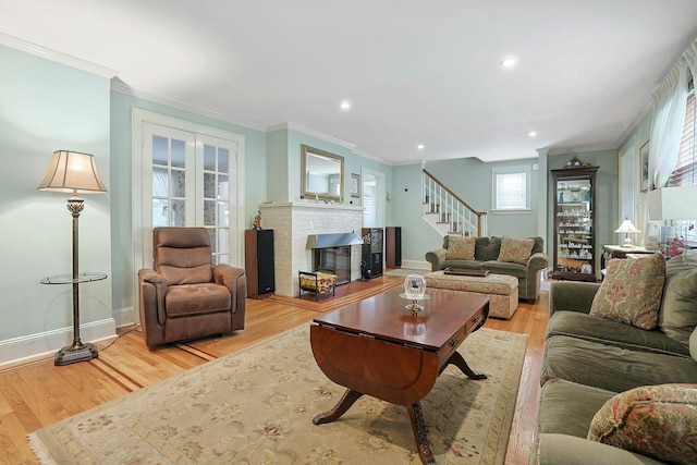 41 Cowdrey St, Yonkers, NY 10701 - living room featuring stairway, a glass covered fireplace, light wood-type flooring, crown molding, and recessed lighting