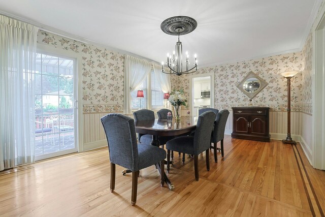 41 Cowdrey St, Yonkers, NY 10701 - dining room with wallpapered walls, crown molding, a chandelier, light wood finished floors, and healthy amount of natural light