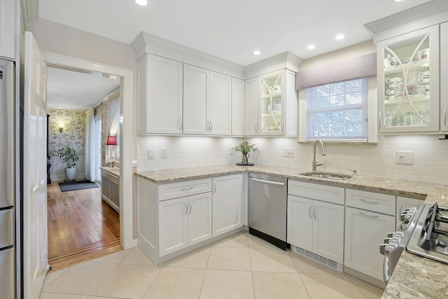41 Cowdrey St, Yonkers, NY 10701 - kitchen with appliances with stainless steel finishes, white cabinetry, backsplash, light stone countertops, and recessed lighting
