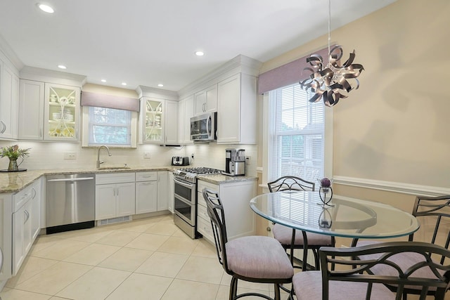41 Cowdrey St, Yonkers, NY 10701 - kitchen with appliances with stainless steel finishes, plenty of natural light, white cabinetry, backsplash, and recessed lighting