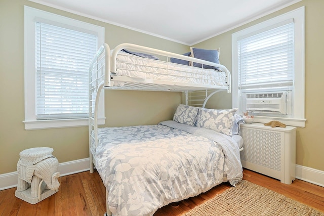 41 Cowdrey St, Yonkers, NY 10701 - bedroom with radiator, wood finished floors, multiple windows, and ornamental molding