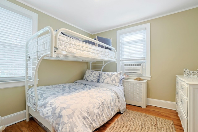 41 Cowdrey St, Yonkers, NY 10701 - bedroom with radiator, cooling unit, wood finished floors, and crown molding
