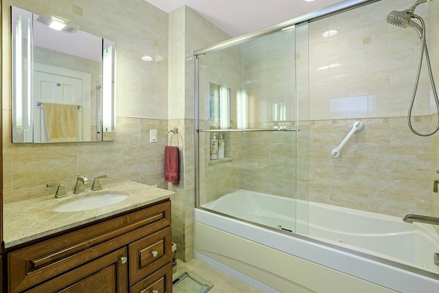41 Cowdrey St, Yonkers, NY 10701 - full bathroom with a combined bath / shower with jetted tub, vanity, tile walls, and tile patterned flooring