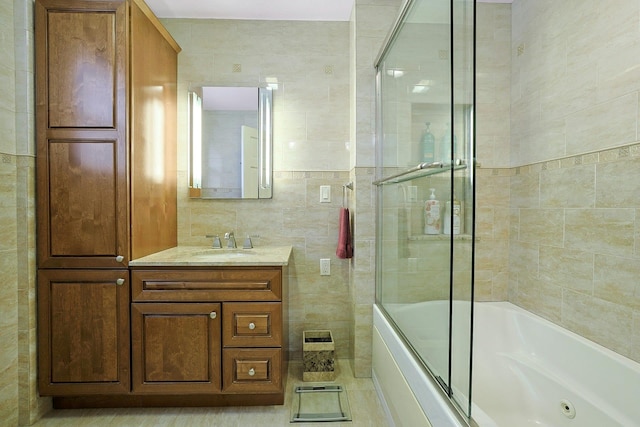 41 Cowdrey St, Yonkers, NY 10701 - full bathroom with tile walls, vanity, and bath / shower combo with glass door