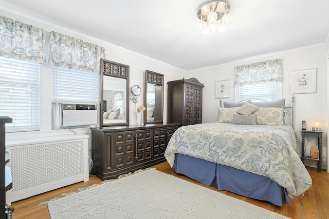 41 Cowdrey St, Yonkers, NY 10701 - bedroom with radiator heating unit, wood finished floors, cooling unit, and crown molding