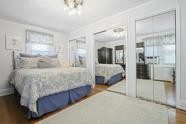 41 Cowdrey St, Yonkers, NY 10701 - bedroom with two closets, crown molding, wood finished floors, a chandelier, and cooling unit