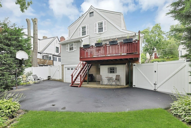 41 Cowdrey St, Yonkers, NY 10701 - rear view of house featuring a gate, stairway, a deck, and a garage