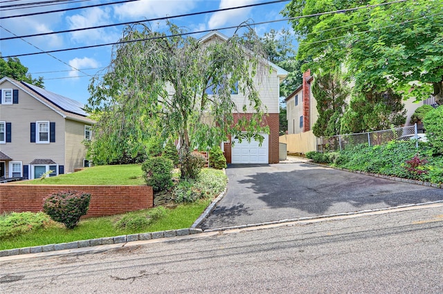 17 Singworth St, Oyster Bay, NY 11771 - view of front facade featuring driveway, a garage, and brick siding