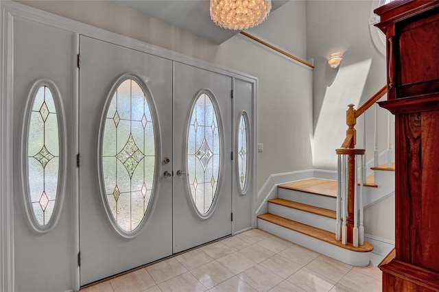 17 Singworth St, Oyster Bay, NY 11771 - entryway featuring stairway, light tile patterned floors, a chandelier, and french doors
