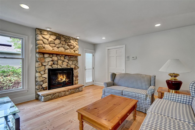 17 Singworth St, Oyster Bay, NY 11771 - living room featuring light wood-type flooring, a stone fireplace, and recessed lighting