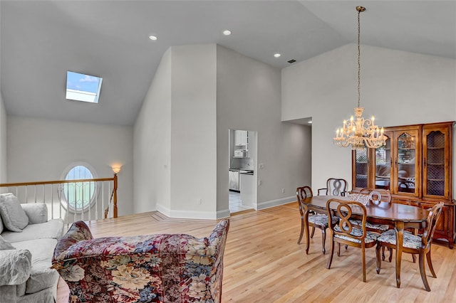 17 Singworth St, Oyster Bay, NY 11771 - dining area featuring high vaulted ceiling, a chandelier, light wood finished floors, and a skylight