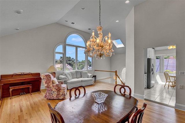 17 Singworth St, Oyster Bay, NY 11771 - dining space with high vaulted ceiling, a chandelier, and light wood finished floors