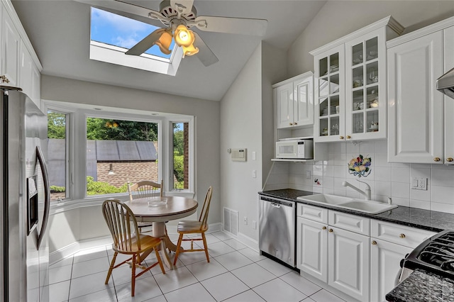 17 Singworth St, Oyster Bay, NY 11771 - kitchen with stainless steel appliances, ceiling fan, a skylight, lofted ceiling, and decorative backsplash