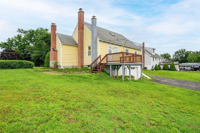33 Grandview Ave, Pawling, NY 12564 - back of property with a deck, driveway, a yard, a chimney, and a garage