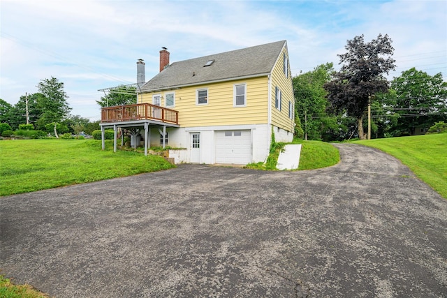 33 Grandview Ave, Pawling, NY 12564 - rear view of house with a wooden deck, a chimney, asphalt driveway, a yard, and an attached garage