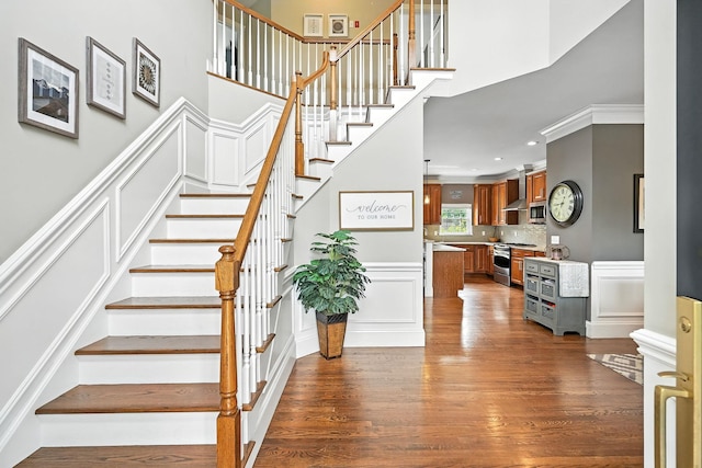 4 Brianna Ln, Yorktown Heights, NY 10598 - staircase with wood finished floors, a decorative wall, a towering ceiling, and recessed lighting