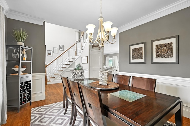 4 Brianna Ln, Yorktown Heights, NY 10598 - dining room featuring ornamental molding, stairs, a chandelier, wood finished floors, and a wainscoted wall