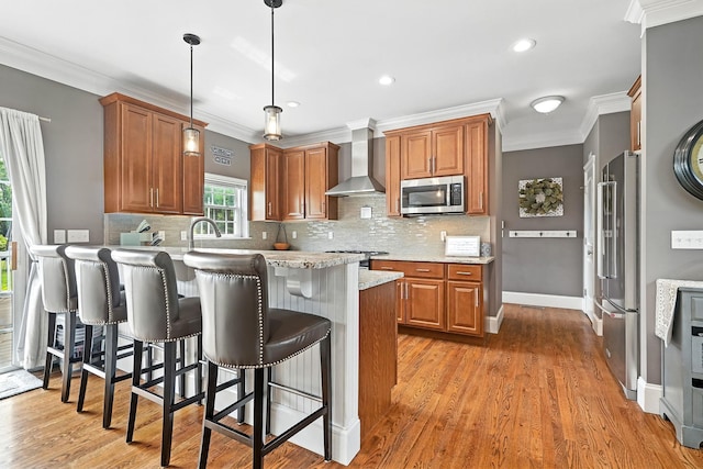 4 Brianna Ln, Yorktown Heights, NY 10598 - kitchen featuring wall chimney range hood, appliances with stainless steel finishes, a peninsula, crown molding, and a breakfast bar