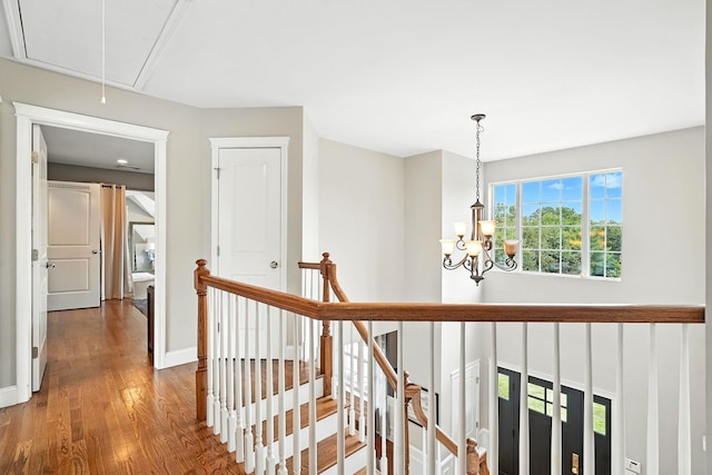 4 Brianna Ln, Yorktown Heights, NY 10598 - hallway featuring an upstairs landing, wood finished floors, attic access, and a chandelier