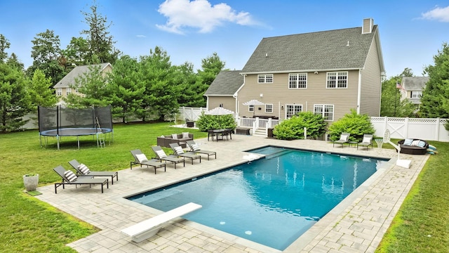 4 Brianna Ln, Yorktown Heights, NY 10598 - view of pool with a trampoline, a patio, a wooden deck, a fenced backyard, and a diving board