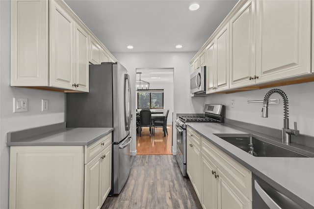 24 Wild Birch Farms, Cortlandt Manor, NY 10567 - kitchen with appliances with stainless steel finishes, dark wood-style flooring, recessed lighting, and a chandelier