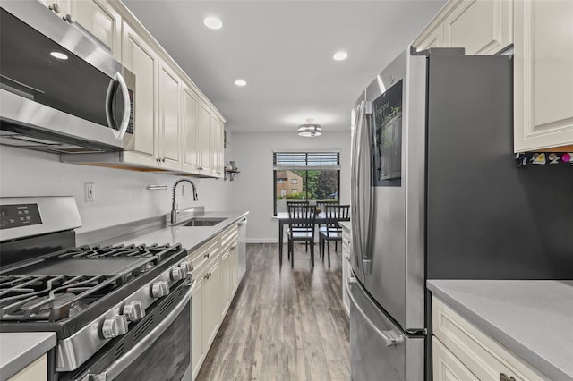 24 Wild Birch Farms, Cortlandt Manor, NY 10567 - kitchen featuring appliances with stainless steel finishes, wood finished floors, light countertops, and recessed lighting