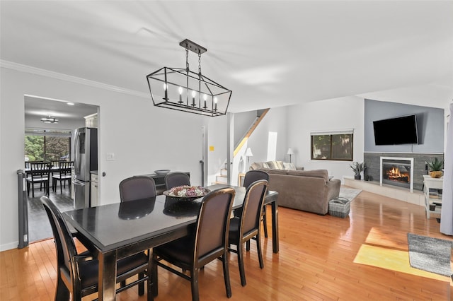 24 Wild Birch Farms, Cortlandt Manor, NY 10567 - dining room with stairs, light wood-style floors, crown molding, and a glass covered fireplace