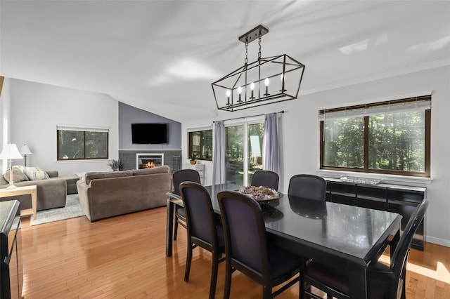 24 Wild Birch Farms, Cortlandt Manor, NY 10567 - dining area with crown molding, a glass covered fireplace, a chandelier, and light wood-style flooring