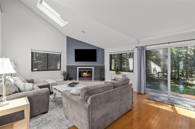 24 Wild Birch Farms, Cortlandt Manor, NY 10567 - living room featuring vaulted ceiling, a tile fireplace, healthy amount of natural light, hardwood / wood-style floors, and a skylight