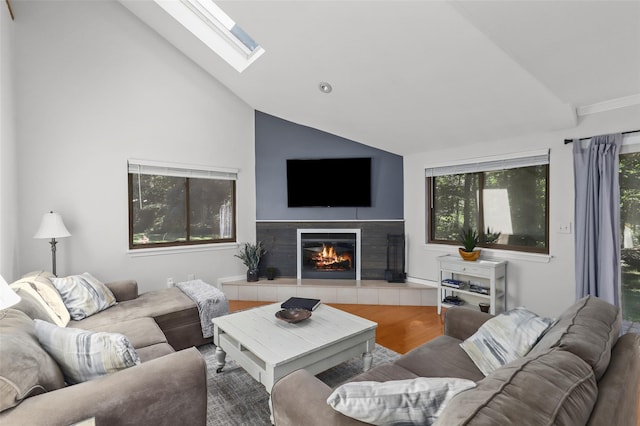 24 Wild Birch Farms, Cortlandt Manor, NY 10567 - living room featuring wood finished floors, a tile fireplace, a skylight, healthy amount of natural light, and high vaulted ceiling