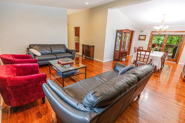 21 Brockton Rd, Spring Valley, NY 10977 - living room featuring a chandelier, vaulted ceiling, wood finished floors, ornamental molding, and recessed lighting