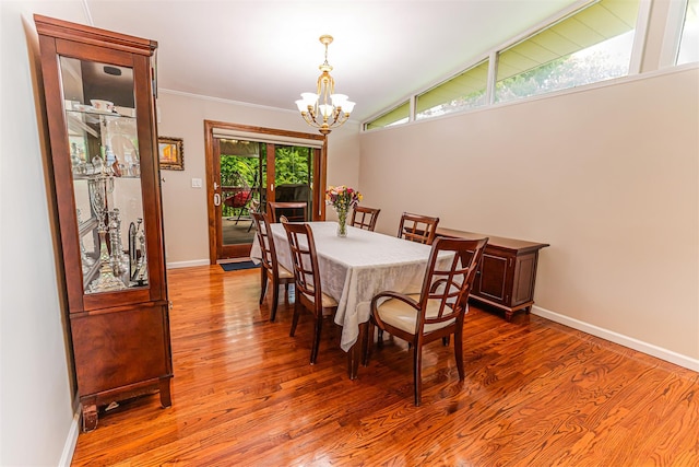 21 Brockton Rd, Spring Valley, NY 10977 - dining area with a chandelier, wood finished floors, ornamental molding, and vaulted ceiling