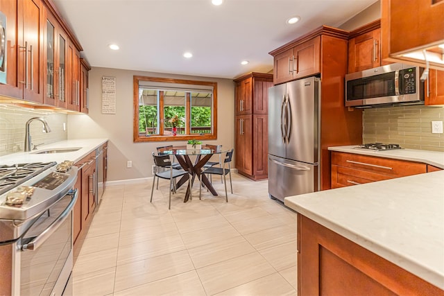 21 Brockton Rd, Spring Valley, NY 10977 - kitchen with appliances with stainless steel finishes, tasteful backsplash, light countertops, brown cabinets, and recessed lighting