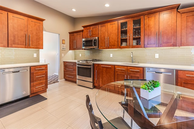 21 Brockton Rd, Spring Valley, NY 10977 - kitchen with appliances with stainless steel finishes, light countertops, tasteful backsplash, glass insert cabinets, and recessed lighting