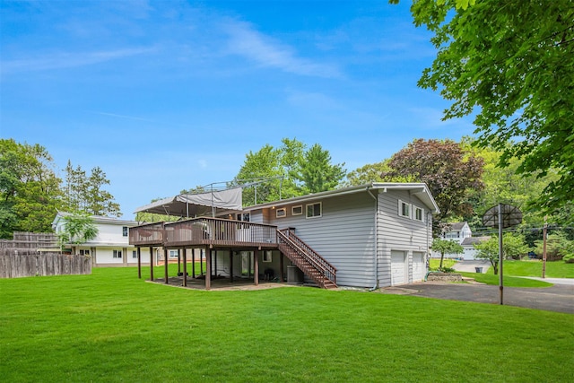 21 Brockton Rd, Spring Valley, NY 10977 - back of property with stairs, a wooden deck, a garage, and asphalt driveway