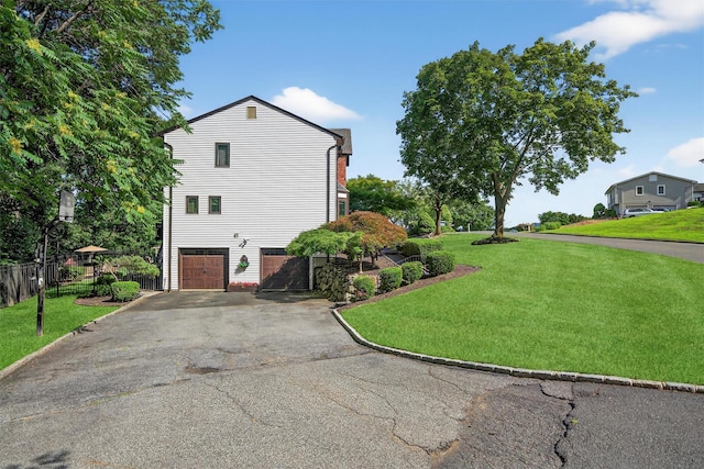 70 Walter Dr, Stony Point, NY 10980 - view of side of property with a garage and asphalt driveway