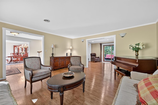 70 Walter Dr, Stony Point, NY 10980 - living area with light wood-style flooring, crown molding, and a chandelier