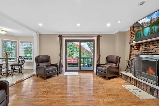 70 Walter Dr, Stony Point, NY 10980 - living room with light wood-type flooring, crown molding, healthy amount of natural light, a brick fireplace, and recessed lighting