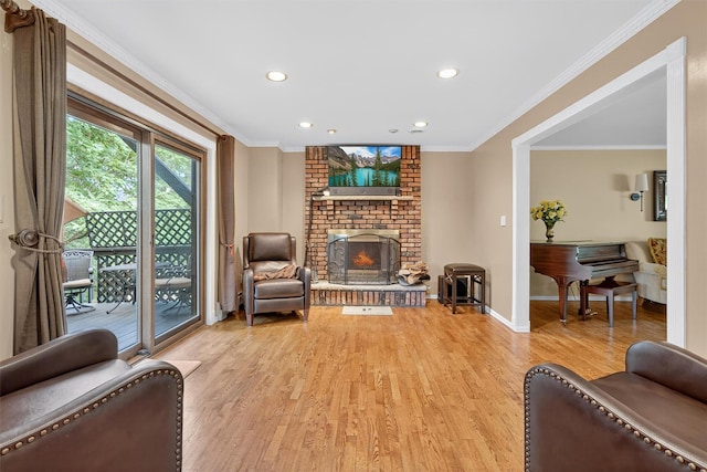 70 Walter Dr, Stony Point, NY 10980 - living area with light wood finished floors, recessed lighting, a brick fireplace, and ornamental molding